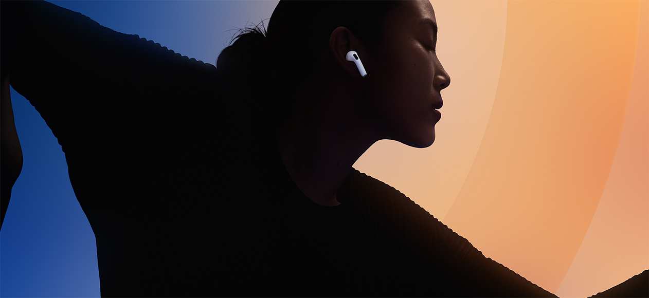 Someone wearing AirPods 5 at sunset